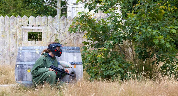 jeune femme jouant au paintball